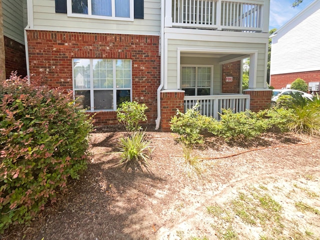 doorway to property featuring covered porch and a balcony