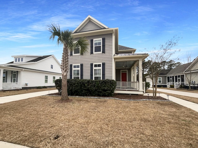 view of front of property with covered porch and a front lawn