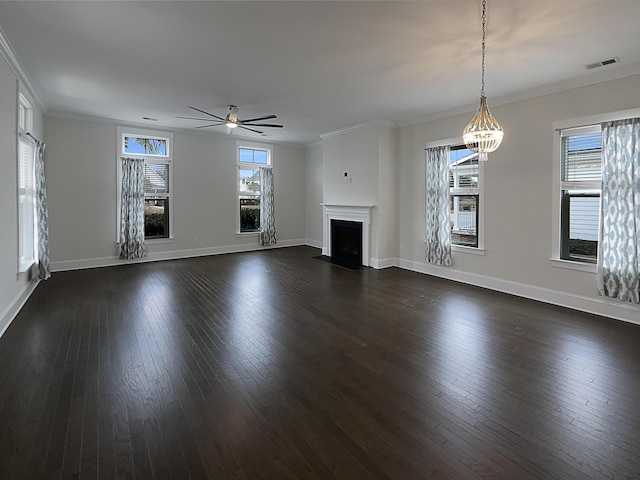 unfurnished living room featuring crown molding, dark hardwood / wood-style flooring, and ceiling fan with notable chandelier