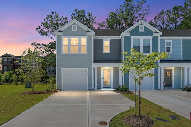 view of front of home with driveway, a garage, and a front lawn