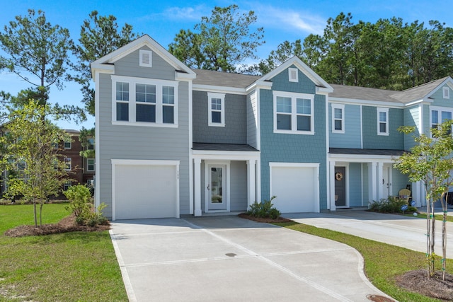 view of front facade with concrete driveway, a front lawn, and an attached garage