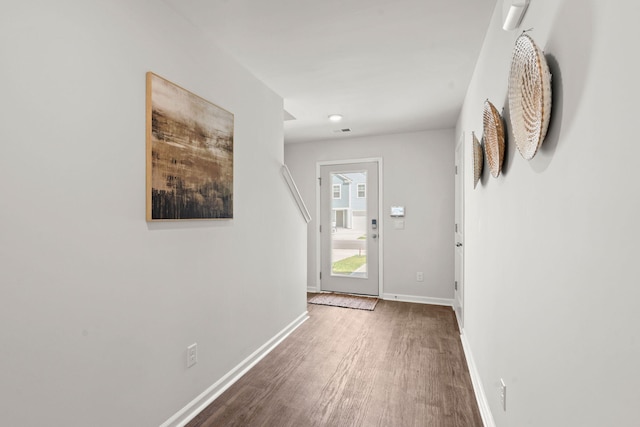 entryway featuring dark wood-style flooring, visible vents, and baseboards