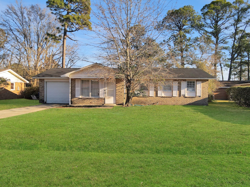 ranch-style house with a front lawn and a garage