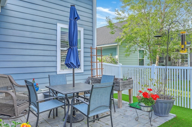 view of patio / terrace featuring outdoor dining area and fence