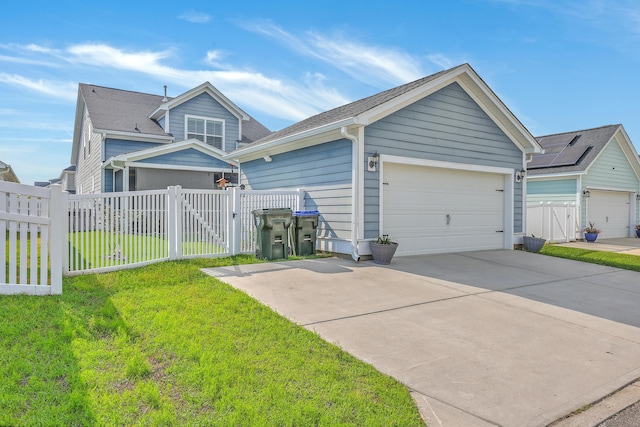 view of front of house featuring a garage, fence, a gate, and a front lawn