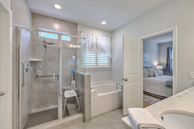 ensuite bathroom with ensuite bathroom, a bath, plenty of natural light, and a stall shower