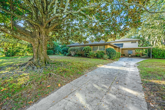 tri-level home featuring a front yard and a carport