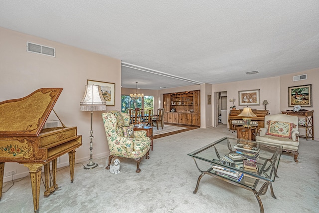 carpeted living room featuring a textured ceiling and a chandelier