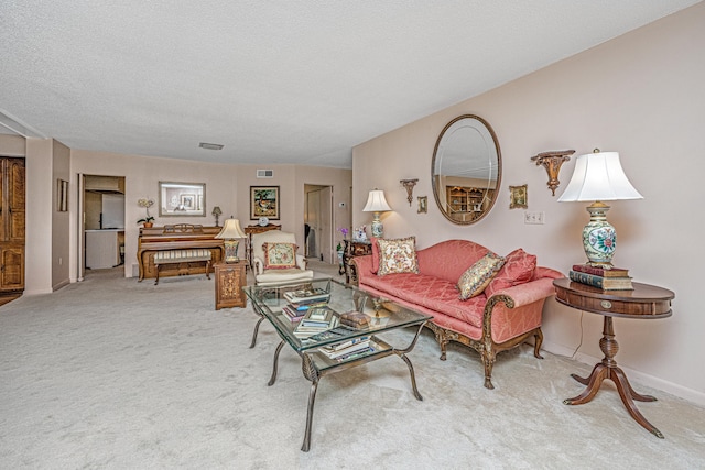 carpeted living room with a textured ceiling