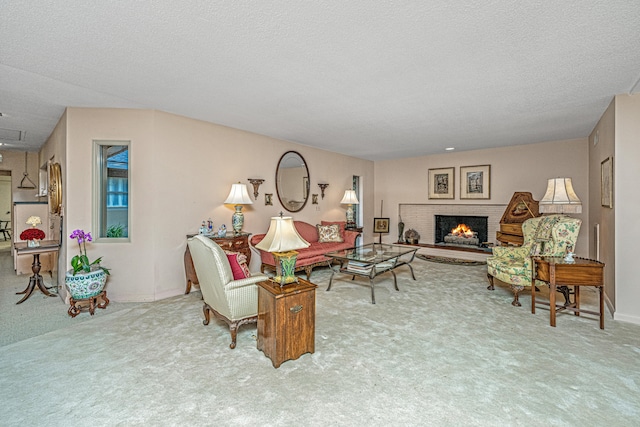 living room featuring carpet, a textured ceiling, and a brick fireplace