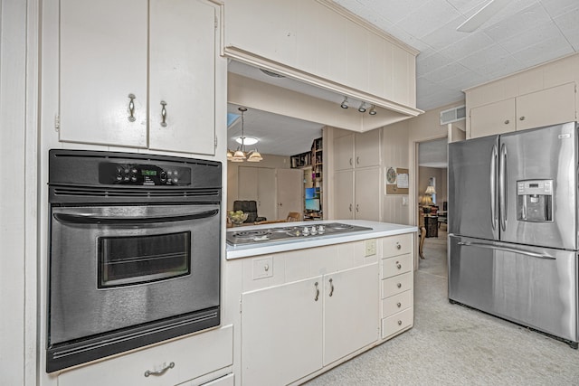 kitchen with hanging light fixtures, light colored carpet, and appliances with stainless steel finishes