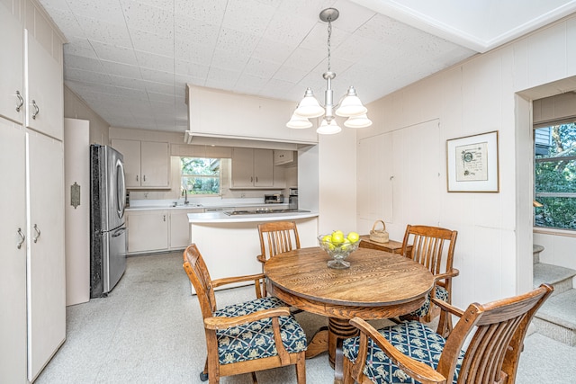 dining room with plenty of natural light, a chandelier, and sink