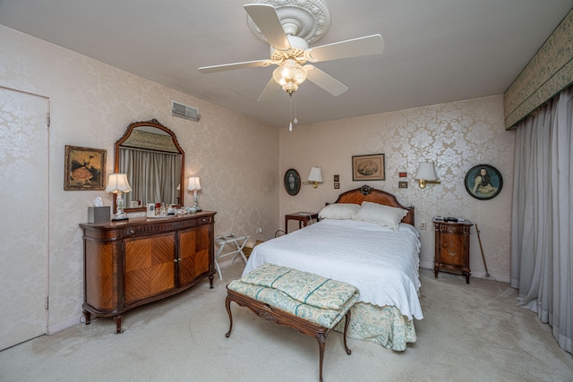 bedroom featuring ceiling fan and light carpet