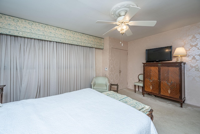 bedroom featuring light colored carpet and ceiling fan