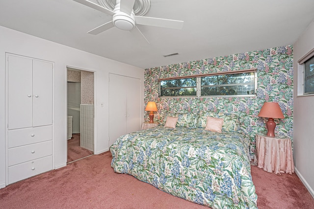 carpeted bedroom featuring two closets and ceiling fan