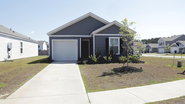view of front of property featuring concrete driveway, a garage, and a front yard