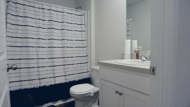 bathroom featuring toilet and vanity