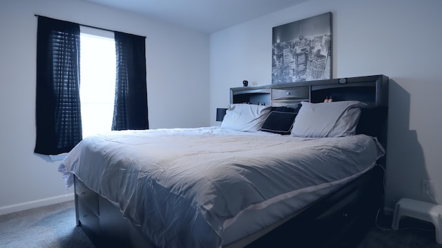 carpeted bedroom featuring baseboards