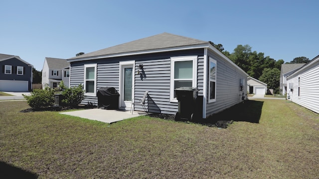back of property featuring a yard and a patio