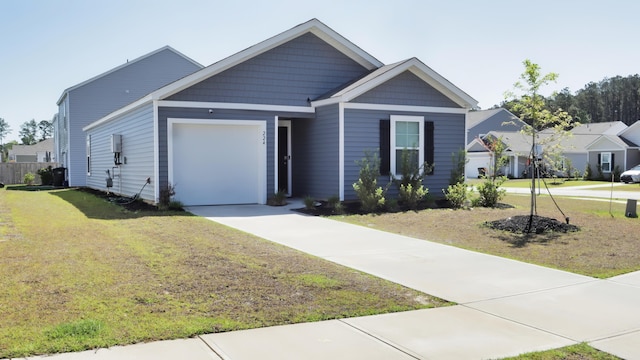 view of front of home with an attached garage, concrete driveway, and a front yard