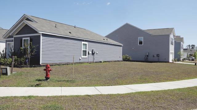 view of home's exterior with a lawn