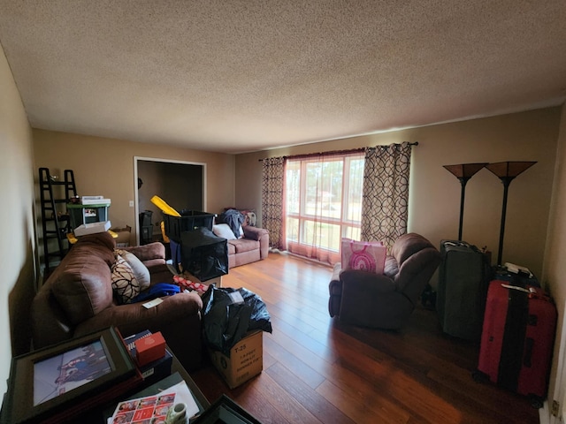 living room featuring hardwood / wood-style flooring and a textured ceiling