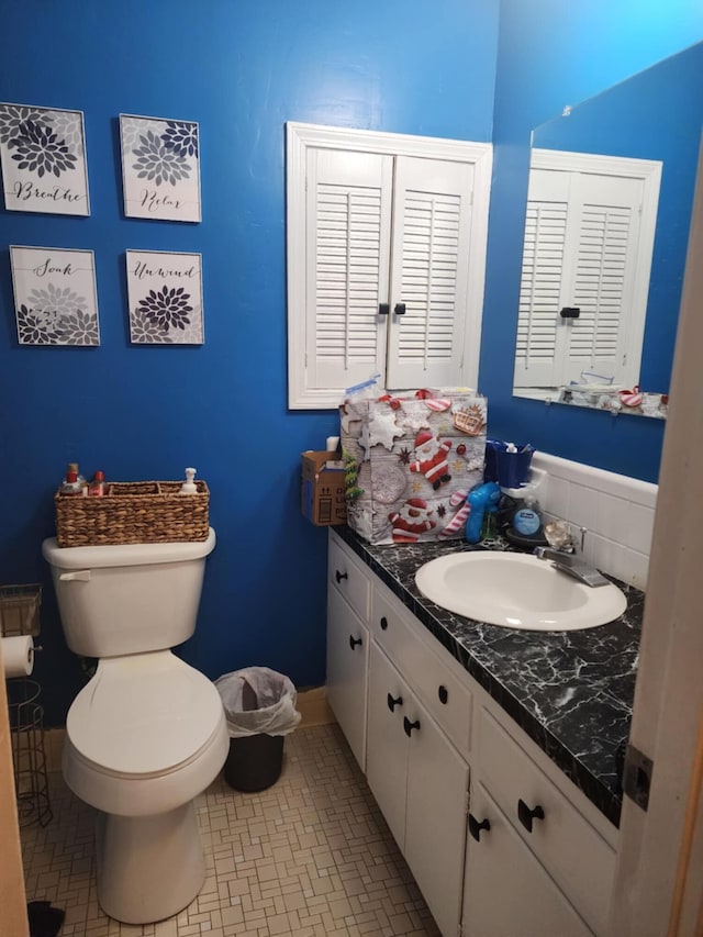 bathroom featuring toilet, vanity, and tile patterned floors