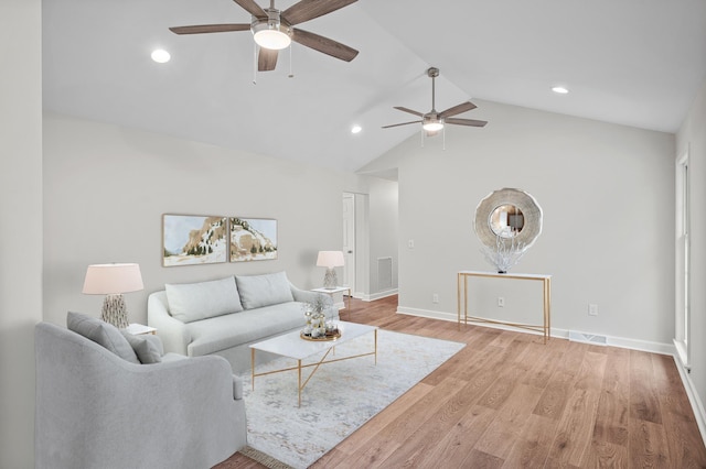 living room with light hardwood / wood-style flooring, ceiling fan, and vaulted ceiling