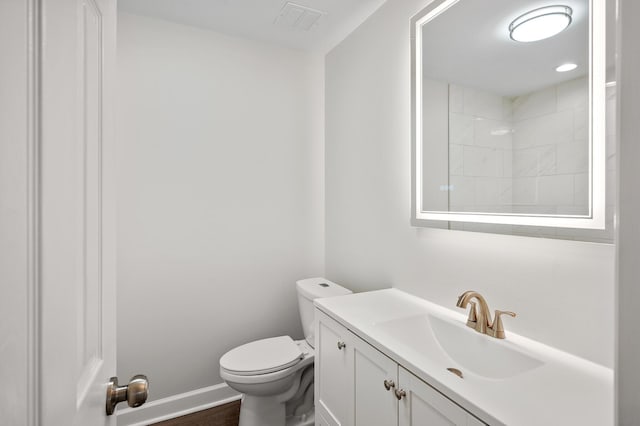 bathroom featuring hardwood / wood-style flooring, vanity, and toilet