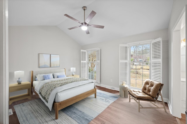 bedroom with ceiling fan, vaulted ceiling, and light hardwood / wood-style flooring