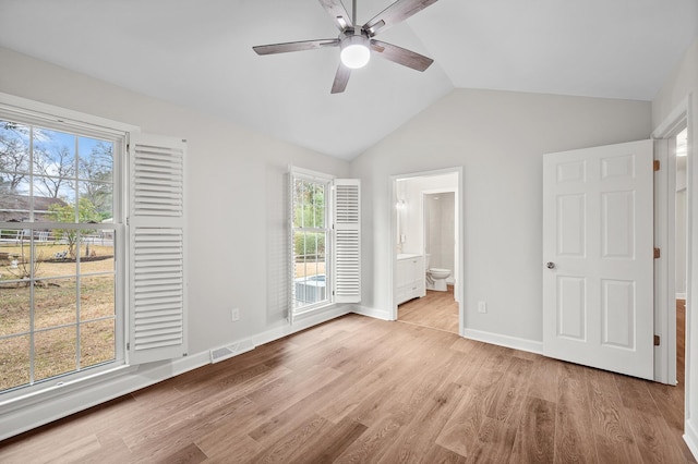 unfurnished bedroom with vaulted ceiling, ceiling fan, ensuite bathroom, and light hardwood / wood-style floors