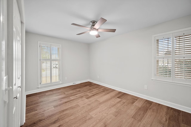 spare room with ceiling fan and light wood-type flooring