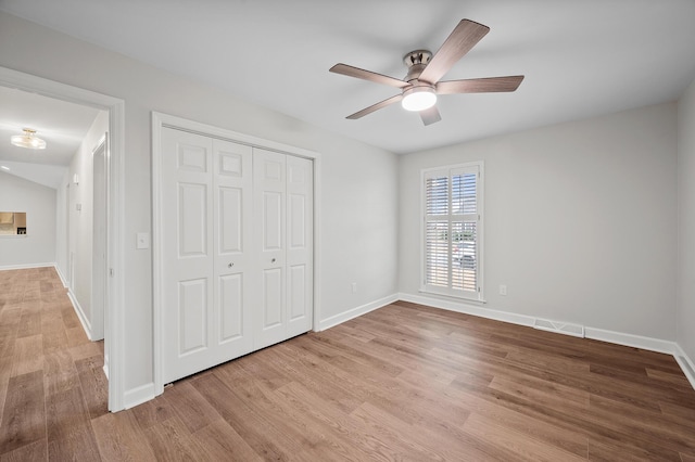 unfurnished bedroom featuring a closet, ceiling fan, and light hardwood / wood-style flooring