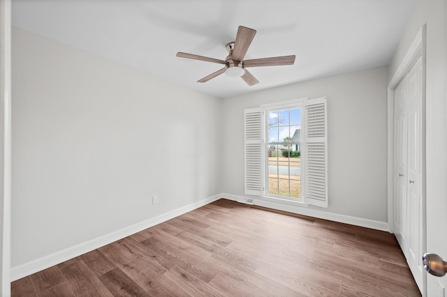 unfurnished bedroom with light hardwood / wood-style flooring, a closet, and ceiling fan