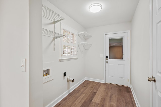 clothes washing area with hookup for a washing machine and dark hardwood / wood-style floors