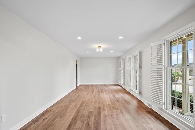 empty room featuring plenty of natural light and light wood-type flooring