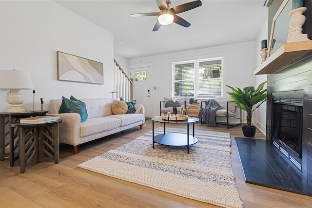 2020 Piper Dr, Charleston, SC 29407 - living room featuring a fireplace with flush hearth, light wood-style flooring, stairway, and a ceiling fan