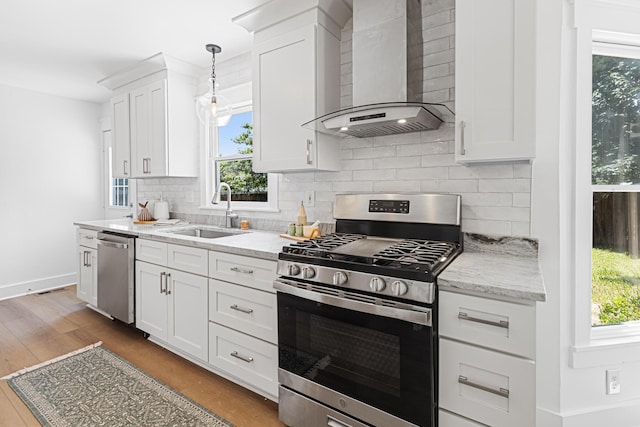 2020 Piper Dr, Charleston, SC 29407 - kitchen with appliances with stainless steel finishes, wall chimney exhaust hood, tasteful backsplash, wood finished floors, and white cabinets