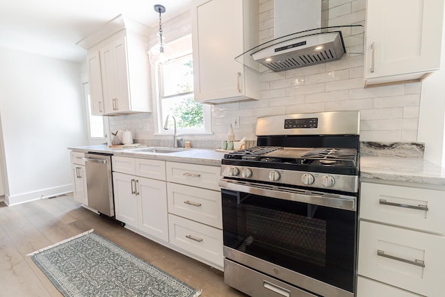 2020 Piper Dr, Charleston, SC 29407 - kitchen with appliances with stainless steel finishes, wall chimney range hood, tasteful backsplash, white cabinetry, and light stone counters