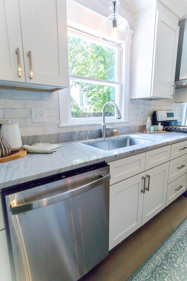2020 Piper Dr, Charleston, SC 29407 - kitchen featuring appliances with stainless steel finishes, plenty of natural light, white cabinetry, and backsplash