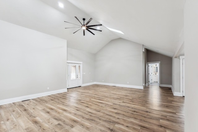 unfurnished living room with lofted ceiling, ceiling fan, and light hardwood / wood-style floors