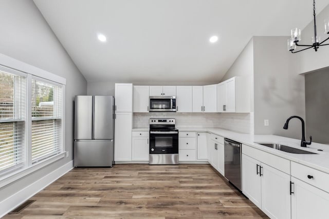 kitchen with white cabinetry, sink, tasteful backsplash, and stainless steel appliances