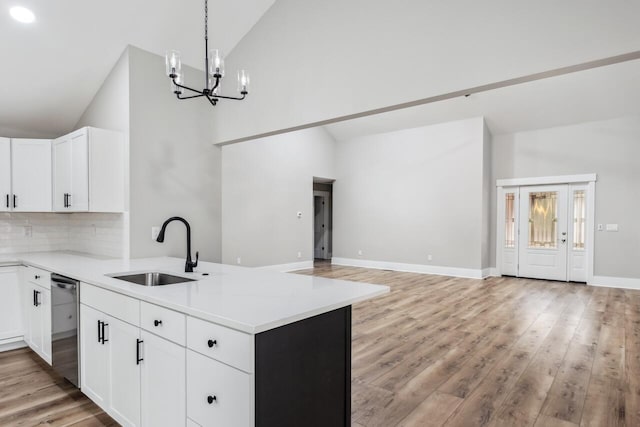 kitchen featuring white cabinetry, high vaulted ceiling, dishwasher, and sink