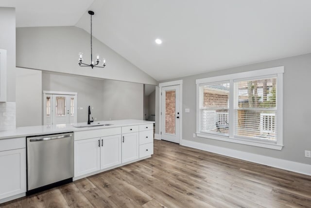 kitchen with white cabinetry, stainless steel dishwasher, decorative light fixtures, and sink