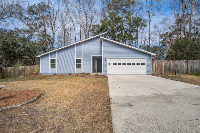 mid-century modern home with an attached garage, fence, a front lawn, and concrete driveway