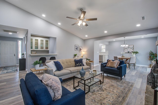 living area with recessed lighting, wood finished floors, visible vents, and baseboards