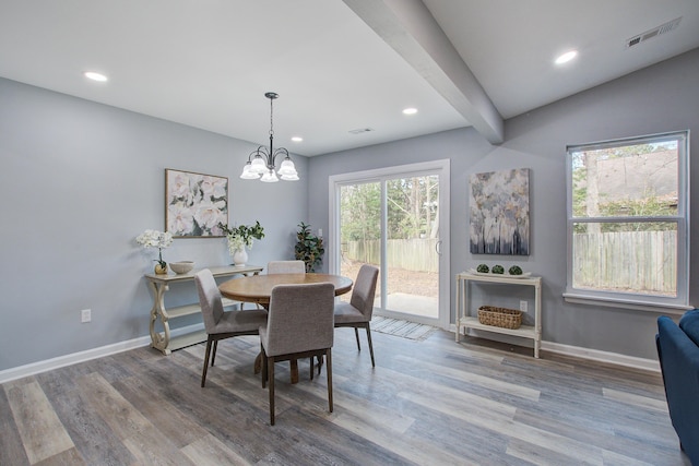 dining area featuring visible vents, baseboards, and wood finished floors