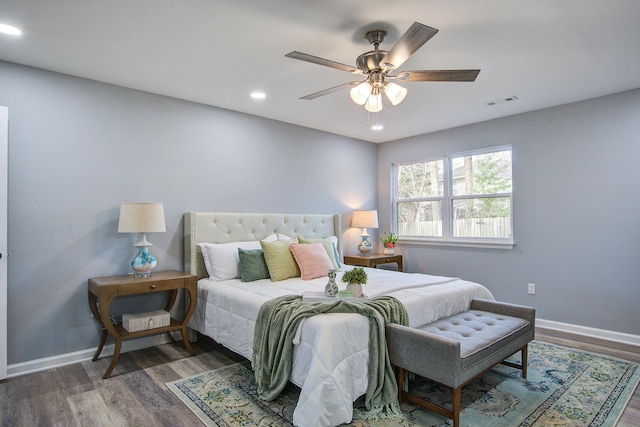 bedroom with recessed lighting, wood finished floors, visible vents, and baseboards