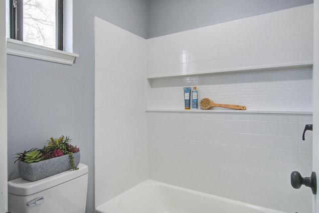 bathroom featuring shower / bathing tub combination and toilet