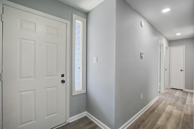 foyer featuring recessed lighting, baseboards, and wood finished floors